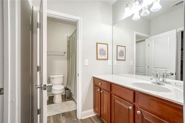 bathroom with hardwood / wood-style floors, vanity, toilet, and a shower with curtain