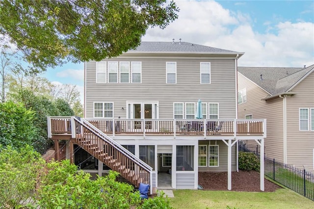 back of house featuring a yard and a wooden deck