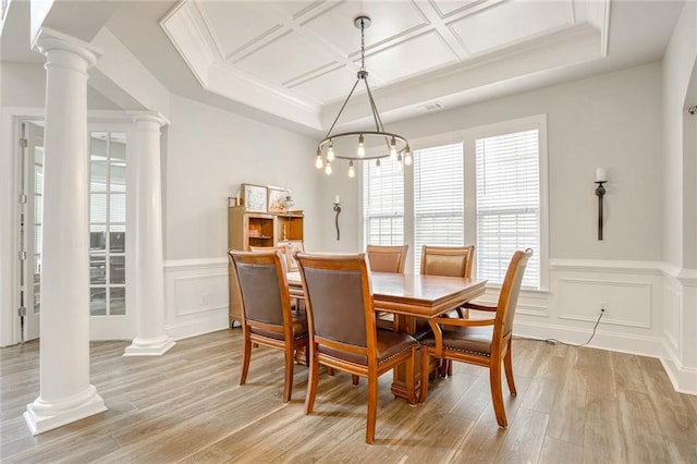 dining room with light hardwood / wood-style floors, coffered ceiling, and a notable chandelier