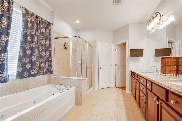 bathroom with plus walk in shower, vanity, a wealth of natural light, and tile patterned flooring