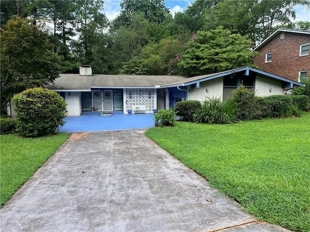 2323 Valleyside Dr, Decatur, GA 30032 - view of front of house with brick siding, a front yard, driveway, and a chimney