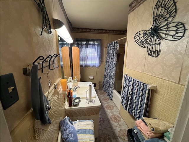 2323 Valleyside Dr, Decatur, GA 30032 - full bath featuring vanity, shower / bath combo with shower curtain, tile patterned floors, and a wainscoted wall