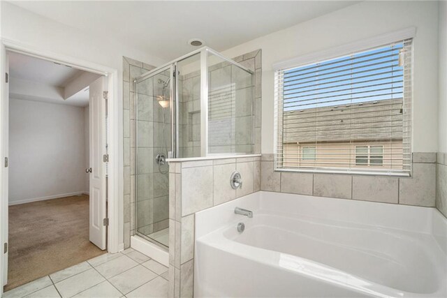 bathroom with tile patterned flooring and separate shower and tub