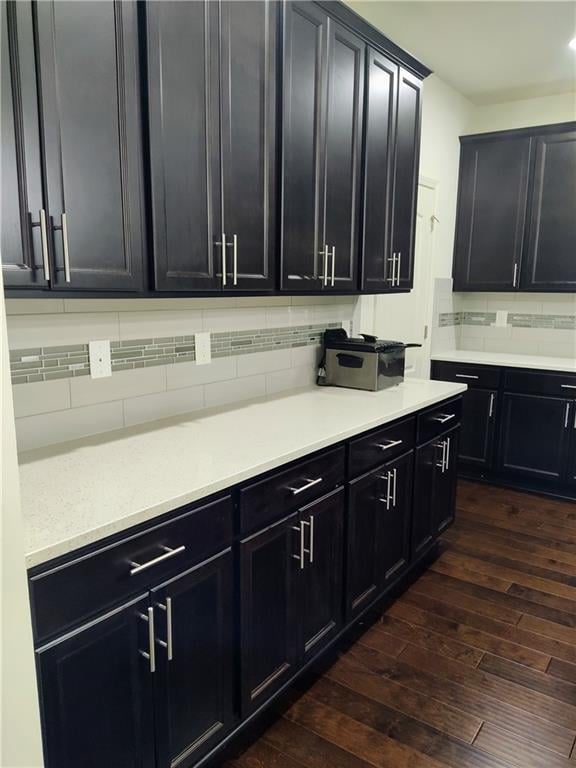 kitchen with dark hardwood / wood-style floors and decorative backsplash