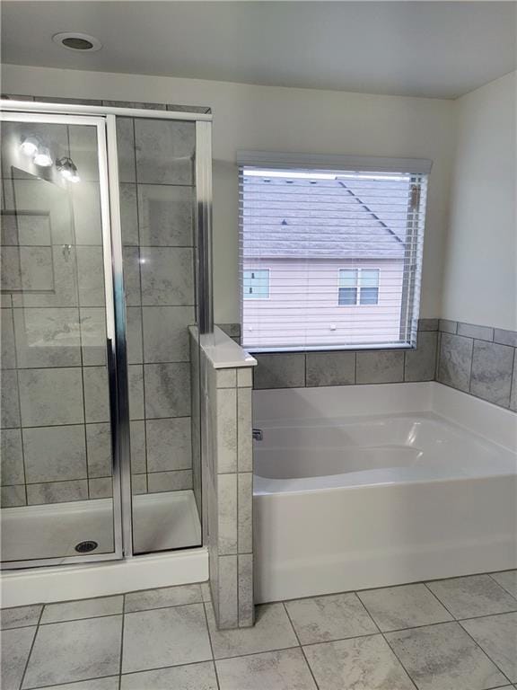 bathroom featuring tile patterned floors and plus walk in shower