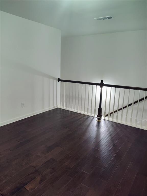 spare room featuring dark hardwood / wood-style flooring