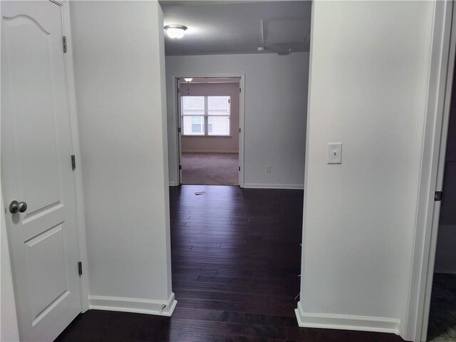 hallway with dark hardwood / wood-style flooring