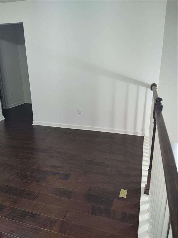 empty room featuring dark hardwood / wood-style flooring