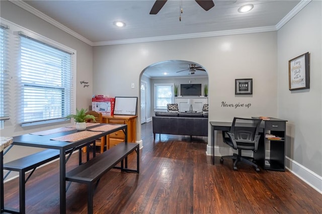 dining area with arched walkways, dark wood-style flooring, a ceiling fan, baseboards, and ornamental molding