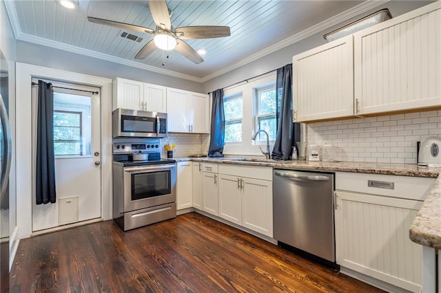 kitchen with light stone counters, stainless steel appliances, a sink, visible vents, and white cabinets