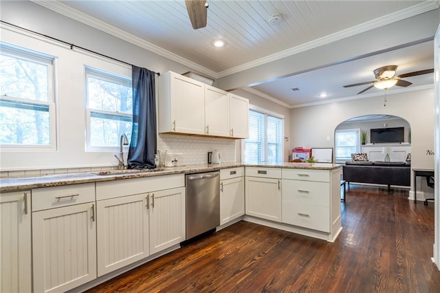 kitchen featuring light stone counters, a ceiling fan, open floor plan, a sink, and dishwasher