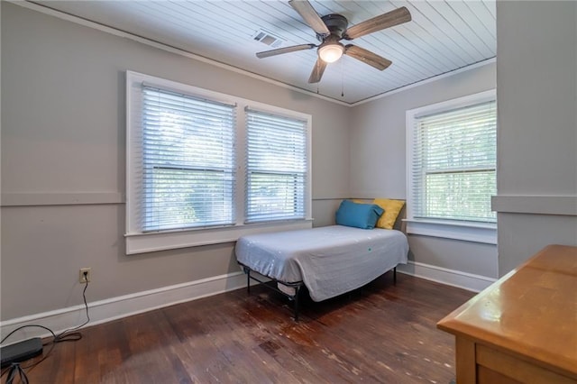 bedroom with multiple windows, visible vents, dark wood-style flooring, and ornamental molding