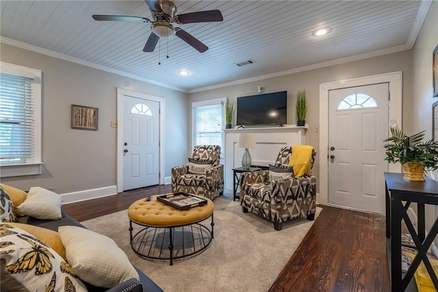 living room featuring baseboards, visible vents, and ornamental molding