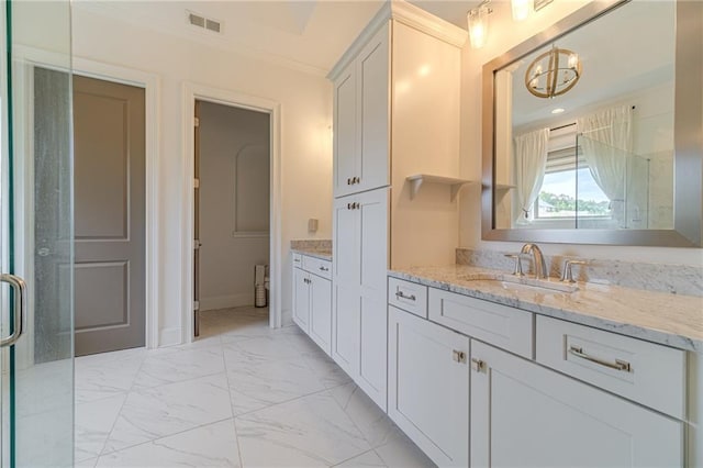 bathroom with vanity and ornamental molding