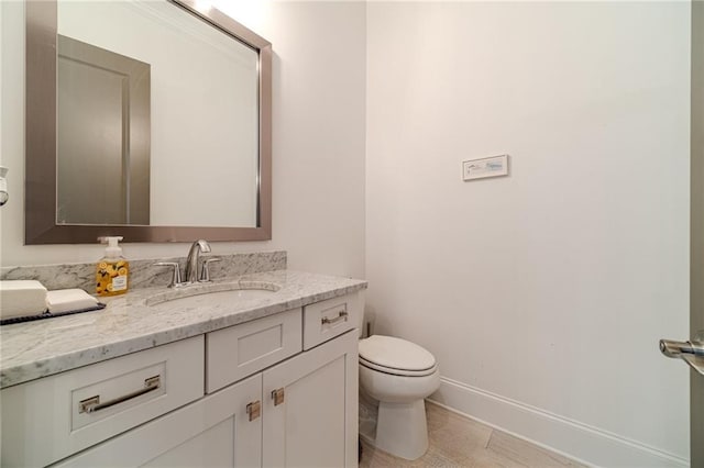 bathroom featuring tile patterned flooring, vanity, and toilet