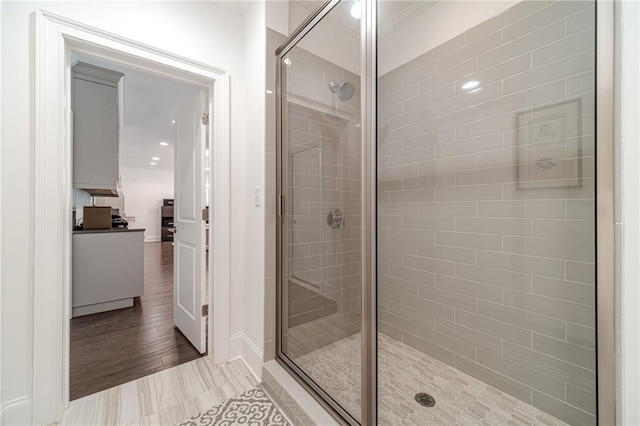 bathroom with tile patterned floors and a shower with door