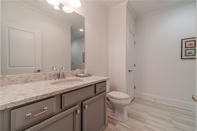 bathroom featuring vanity, toilet, and ornamental molding