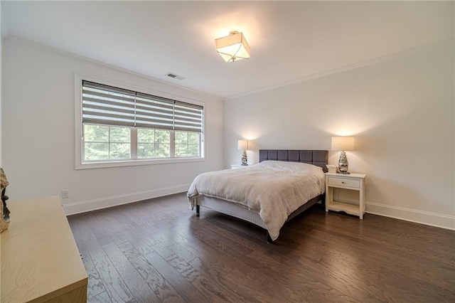 bedroom featuring dark hardwood / wood-style flooring and ornamental molding