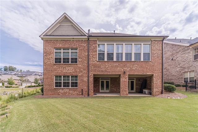 rear view of house featuring a lawn and a patio area