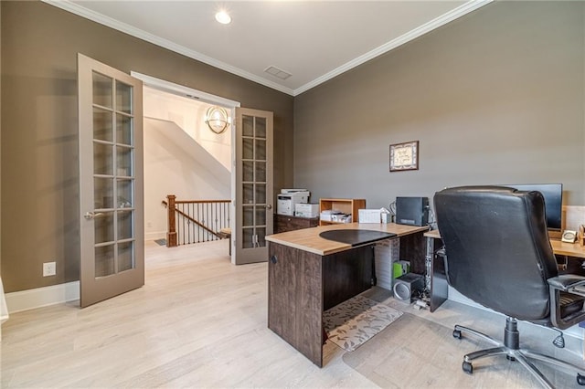 office space featuring light wood-type flooring, ornamental molding, and french doors