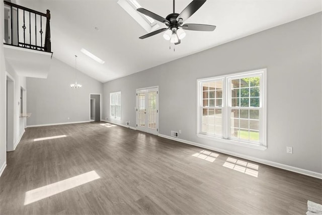 unfurnished living room featuring visible vents, baseboards, ceiling fan with notable chandelier, wood finished floors, and high vaulted ceiling