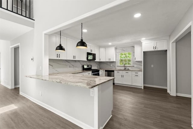 kitchen featuring a sink, white cabinetry, stainless steel appliances, a peninsula, and light stone countertops