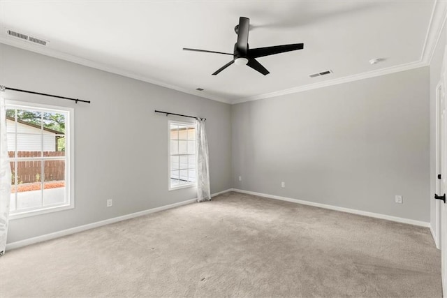 spare room featuring a wealth of natural light, visible vents, and baseboards