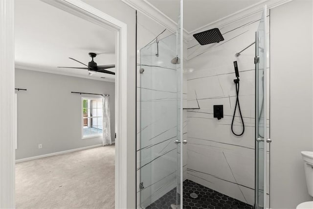 bathroom featuring toilet, a shower stall, and crown molding