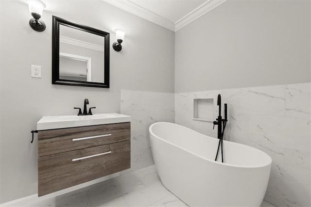 full bathroom featuring marble finish floor, wainscoting, crown molding, a freestanding bath, and vanity