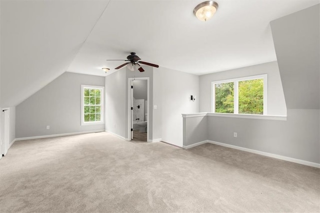 bonus room featuring vaulted ceiling, baseboards, a ceiling fan, and carpet floors