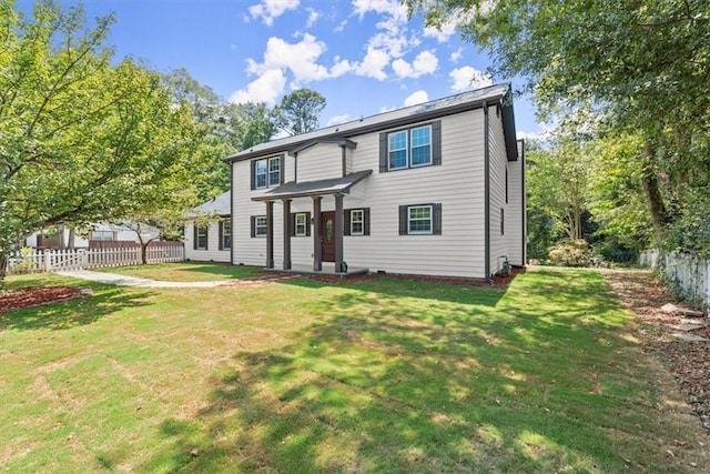 view of front facade with a front yard and fence