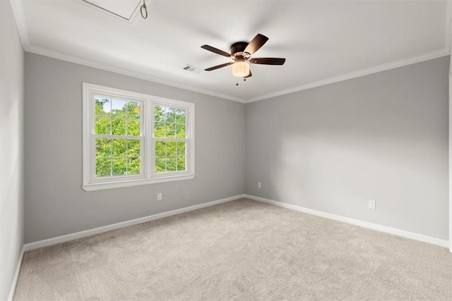 spare room featuring visible vents, ornamental molding, carpet, baseboards, and ceiling fan