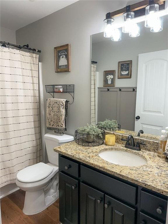 45 Albright Ct, Commerce, GA 30529 - bathroom with wood finished floors, curtained shower, vanity, and toilet