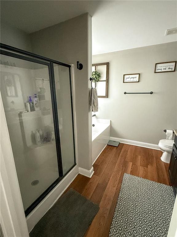 45 Albright Ct, Commerce, GA 30529 - full bath with a bath, toilet, baseboards, wood finished floors, and a shower stall