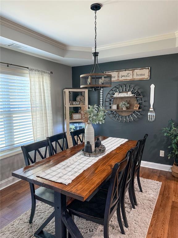 45 Albright Ct, Commerce, GA 30529 - dining room featuring wood-type flooring, baseboards, crown molding, and visible vents