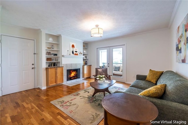 1150 Collier Rd NW Unit G8, Atlanta, GA 30318 - living area featuring light wood finished floors, a fireplace, ornamental molding, french doors, and built in features
