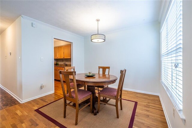 1150 Collier Rd NW Unit G8, Atlanta, GA 30318 - dining room featuring ornamental molding and light wood-style floors