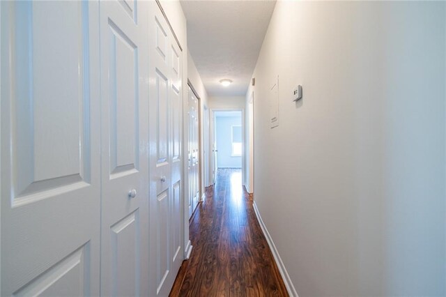 1150 Collier Rd NW Unit G8, Atlanta, GA 30318 - hallway with dark wood-style flooring and baseboards