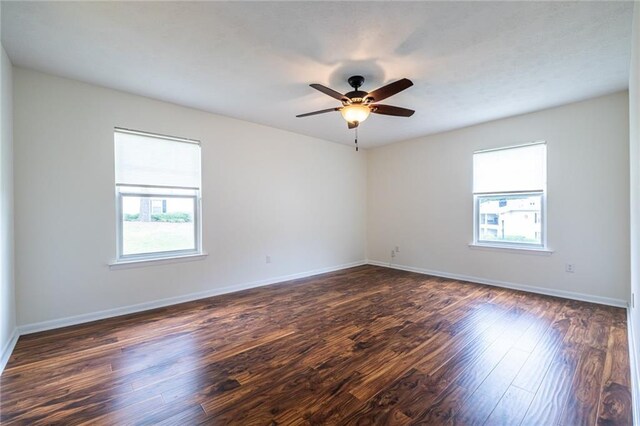1150 Collier Rd NW Unit G8, Atlanta, GA 30318 - empty room with healthy amount of natural light, dark wood-style floors, and ceiling fan