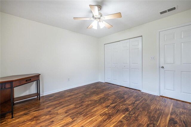 1150 Collier Rd NW Unit G8, Atlanta, GA 30318 - unfurnished bedroom with dark wood-style flooring, a closet, and a ceiling fan