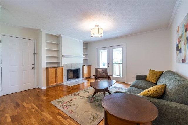 1150 Collier Rd NW Unit G8, Atlanta, GA 30318 - living area featuring light wood-style flooring, french doors, crown molding, a fireplace, and built in features