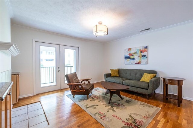 1150 Collier Rd NW Unit G8, Atlanta, GA 30318 - living area featuring crown molding, french doors, and light wood finished floors