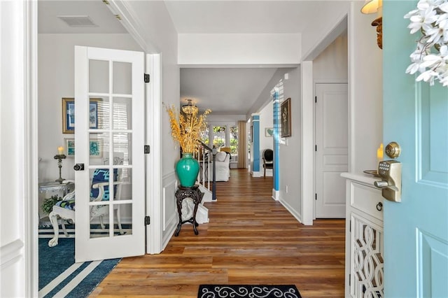 foyer with baseboards, visible vents, french doors, and light wood-type flooring