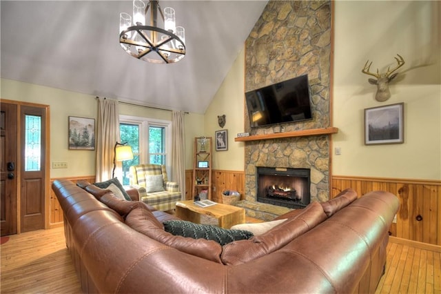276 Pine Ridge Rd, Ellijay, GA 30536 - living area featuring wainscoting, hardwood / wood-style flooring, wooden walls, a chandelier, and a fireplace