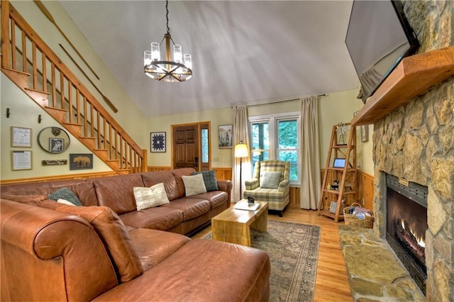 276 Pine Ridge Rd, Ellijay, GA 30536 - living room with a chandelier, a wainscoted wall, a fireplace, light wood finished floors, and stairs