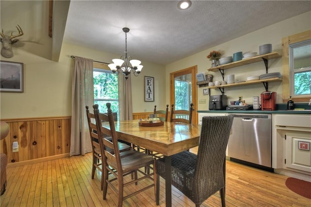 276 Pine Ridge Rd, Ellijay, GA 30536 - dining area with light wood finished floors, a wainscoted wall, a textured ceiling, a chandelier, and wooden walls