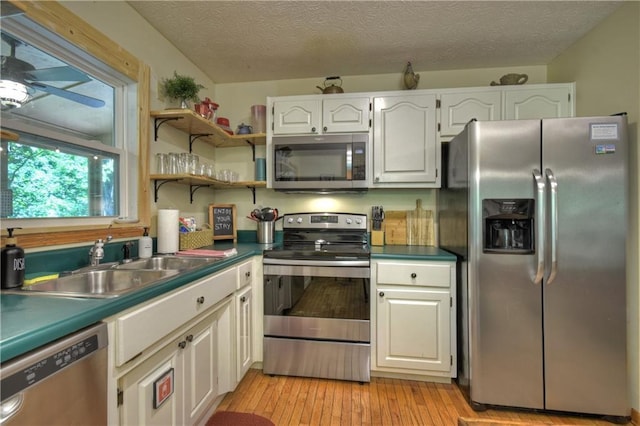 276 Pine Ridge Rd, Ellijay, GA 30536 - kitchen with stainless steel appliances, ceiling fan, white cabinetry, light wood-type flooring, and a textured ceiling