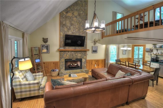 276 Pine Ridge Rd, Ellijay, GA 30536 - living area featuring a chandelier, a wainscoted wall, hardwood / wood-style flooring, high vaulted ceiling, and a stone fireplace