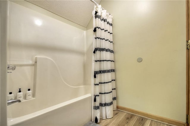 276 Pine Ridge Rd, Ellijay, GA 30536 - bathroom with wood finished floors, shower / bath combo, and a textured ceiling