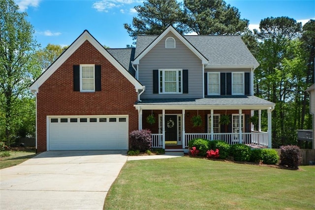 view of front of home featuring an attached garage, concrete driveway, a front yard, and a porch
